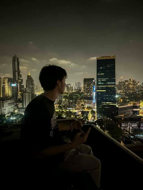 Jed looking across the Bangkok skyline at night
